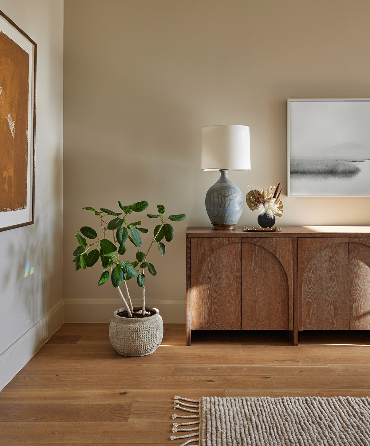 an interior view with midcentury modern furniture and northern wide wood planks on the floor