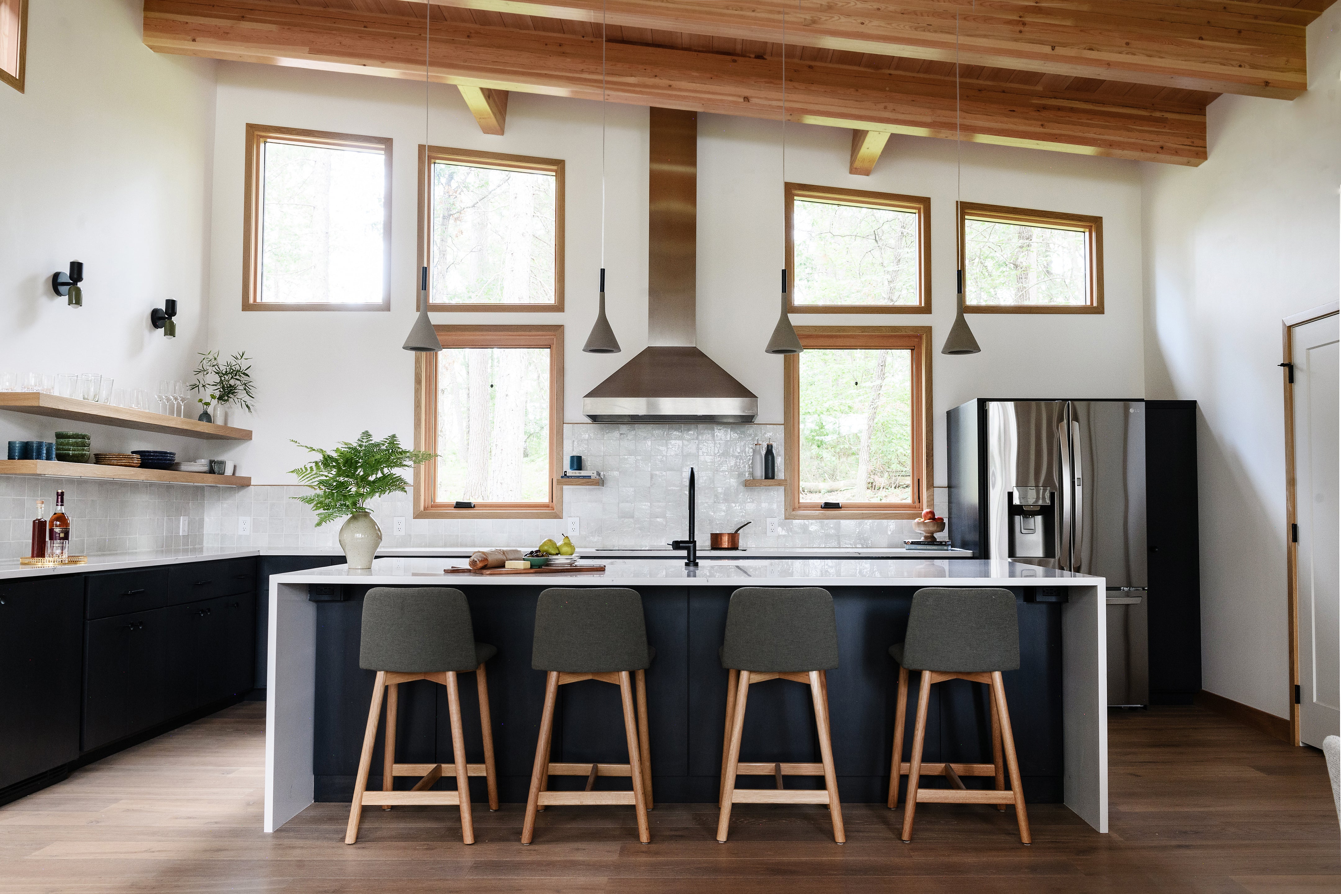 an interior view with midcentury modern furniture and northern wide wood planks on the floor