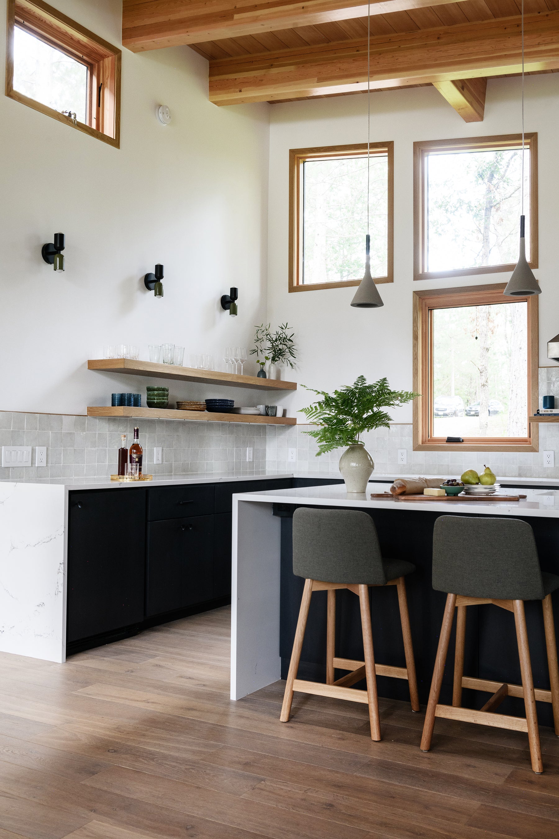 an interior view with midcentury modern furniture and northern wide wood planks on the floor