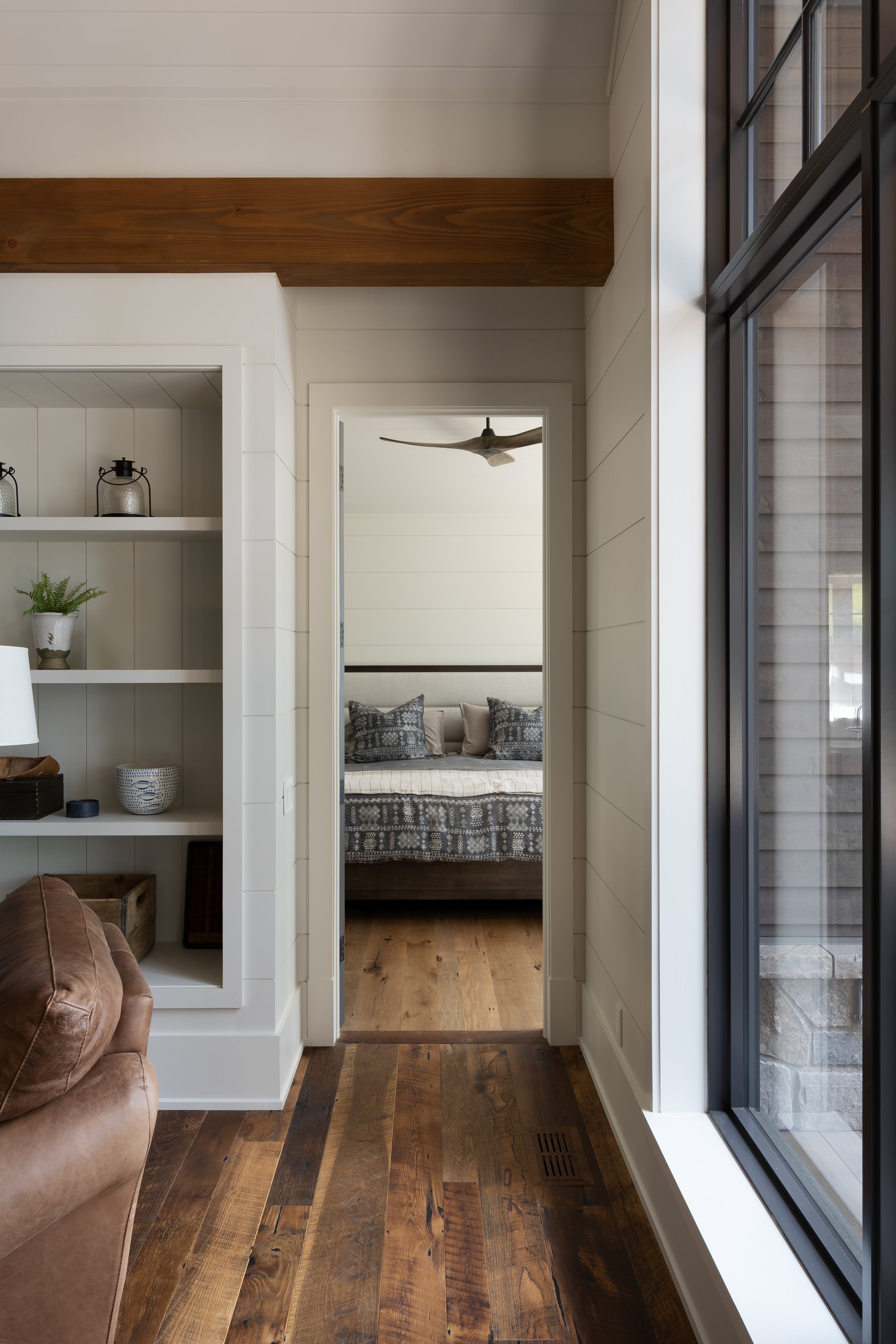 an interior view with midcentury modern furniture and northern wide wood planks on the floor