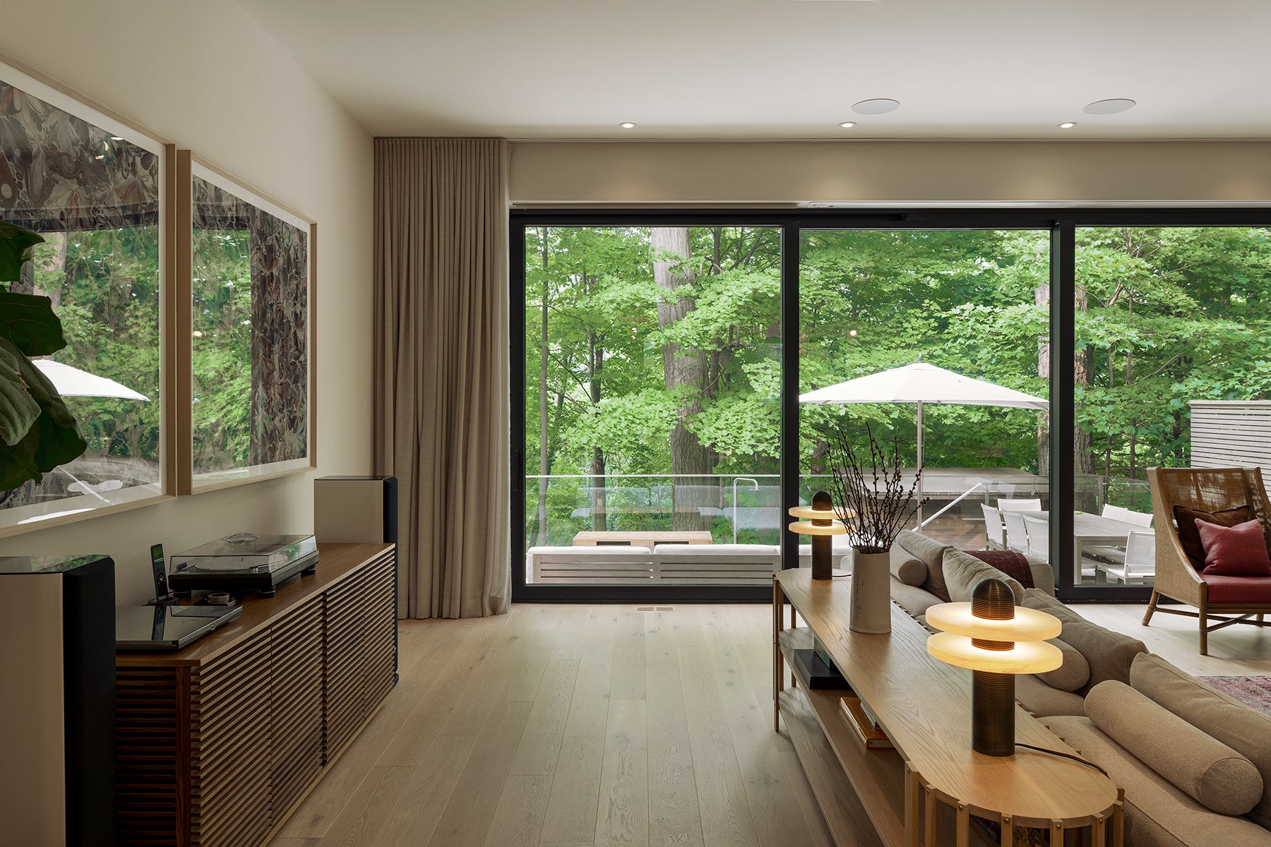 an interior view with midcentury modern furniture and northern wide wood planks on the floor