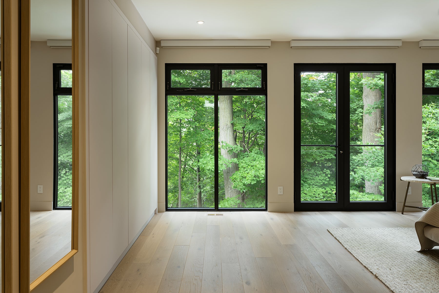 an interior view with midcentury modern furniture and northern wide wood planks on the floor