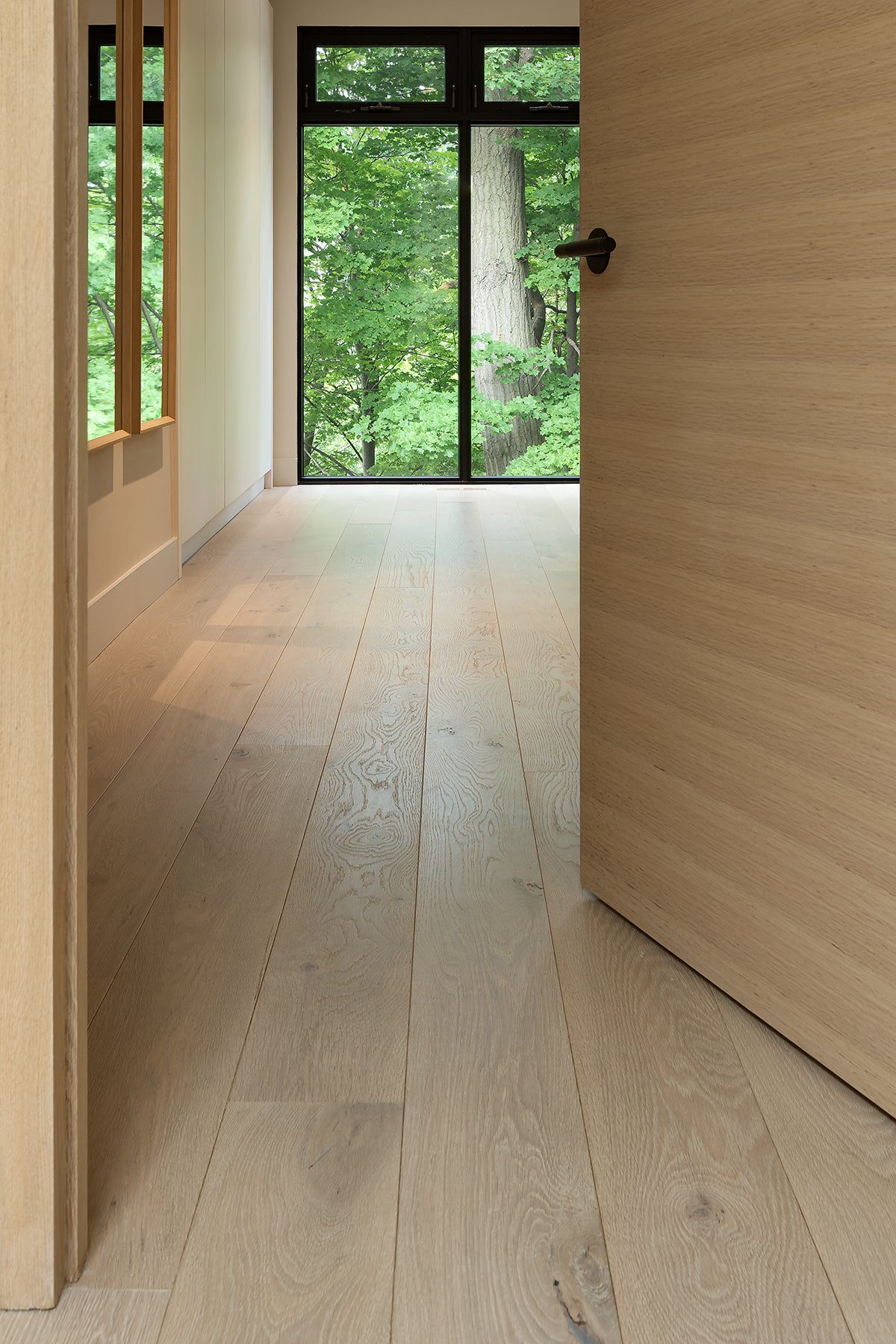 an interior view with midcentury modern furniture and northern wide wood planks on the floor