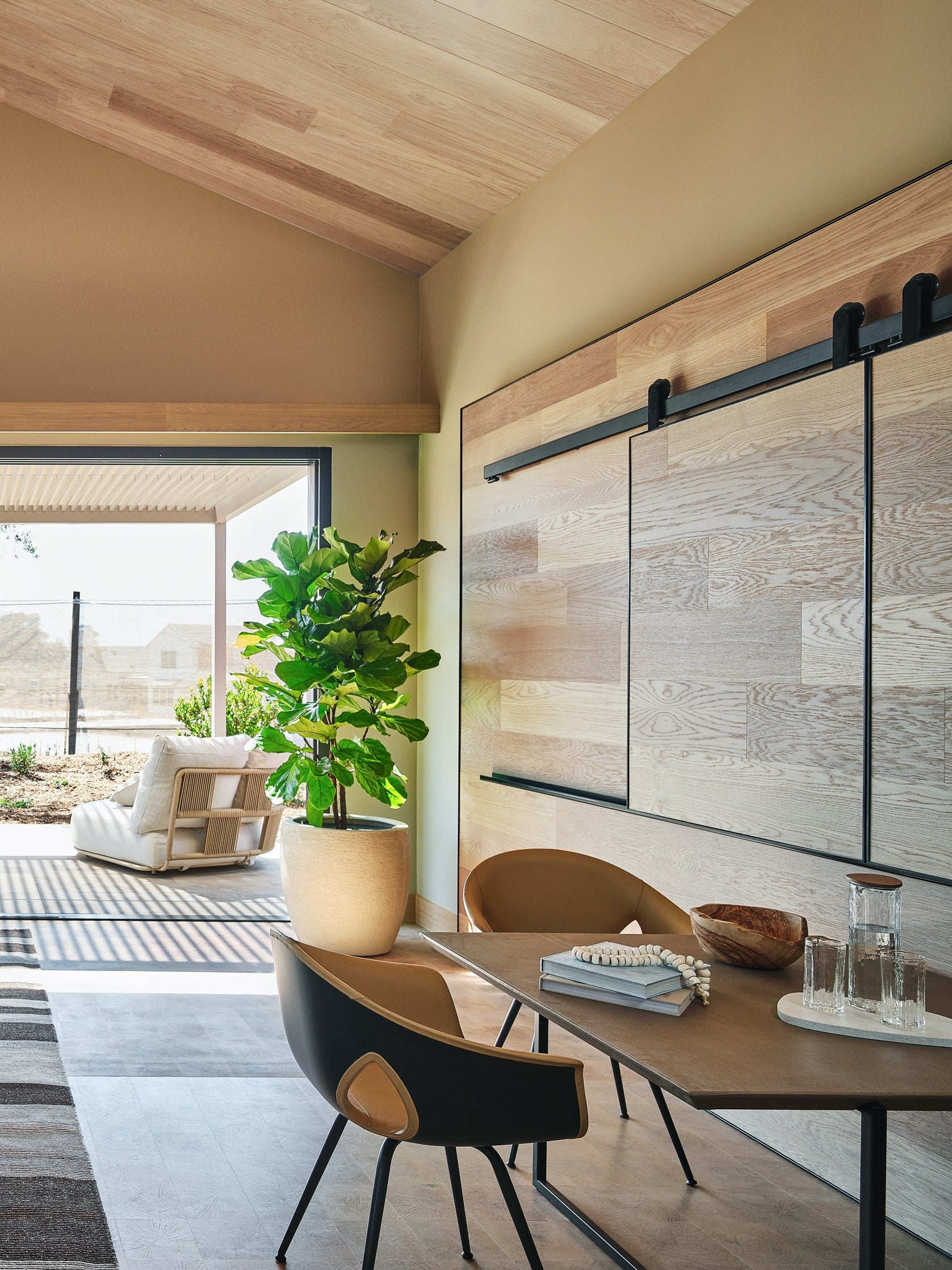 an interior view with midcentury modern furniture and northern wide wood planks on the floor