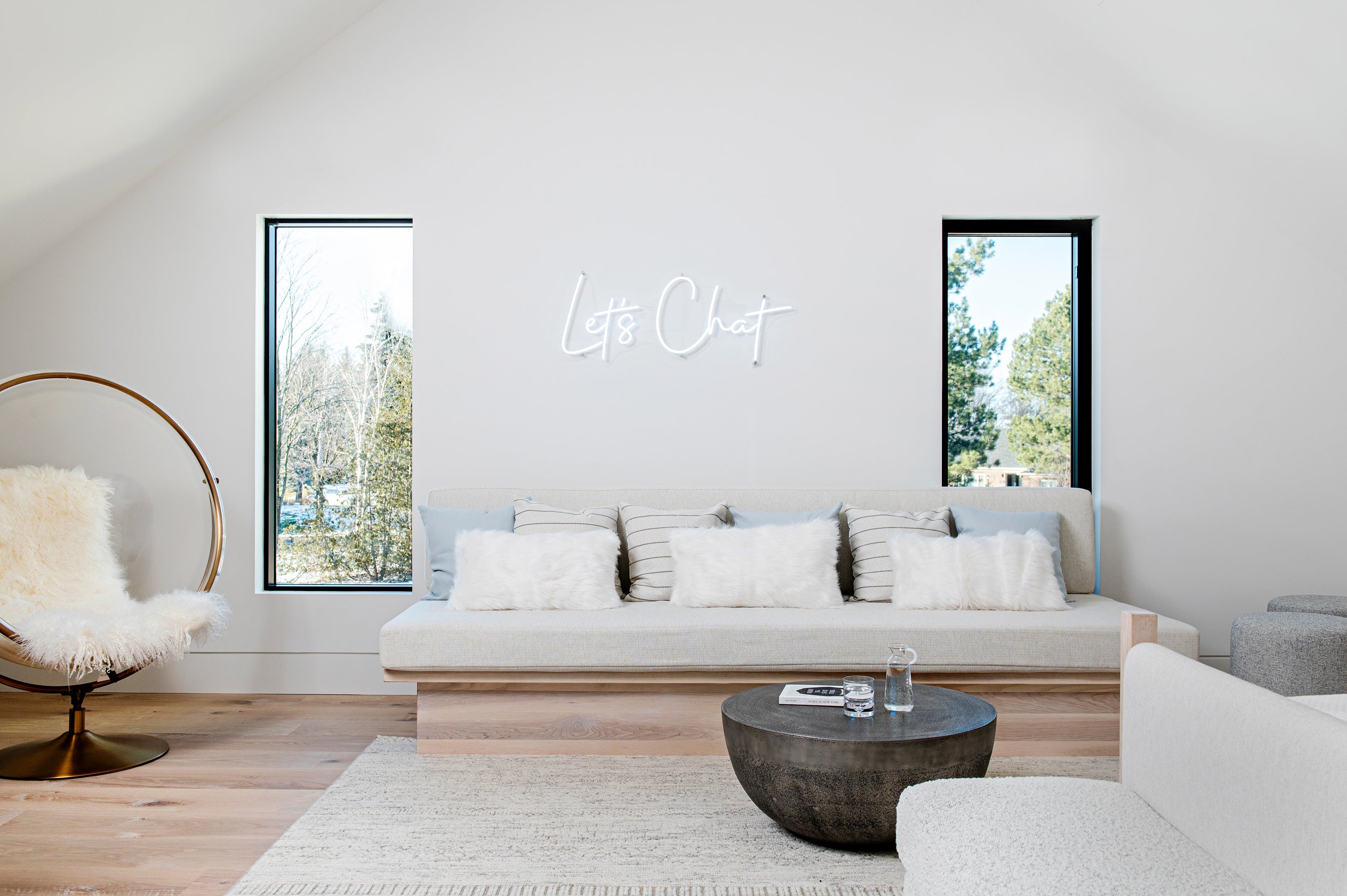 an interior view with midcentury modern furniture and northern wide wood planks on the floor